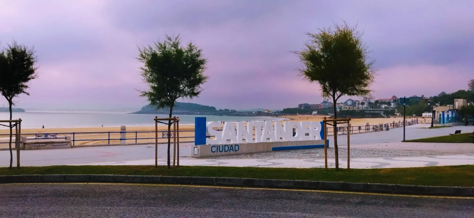 Cartel en la segunda playa de El Sardinero en la ciudad de Santander. Al fondo se ve la playa y unos árboles.