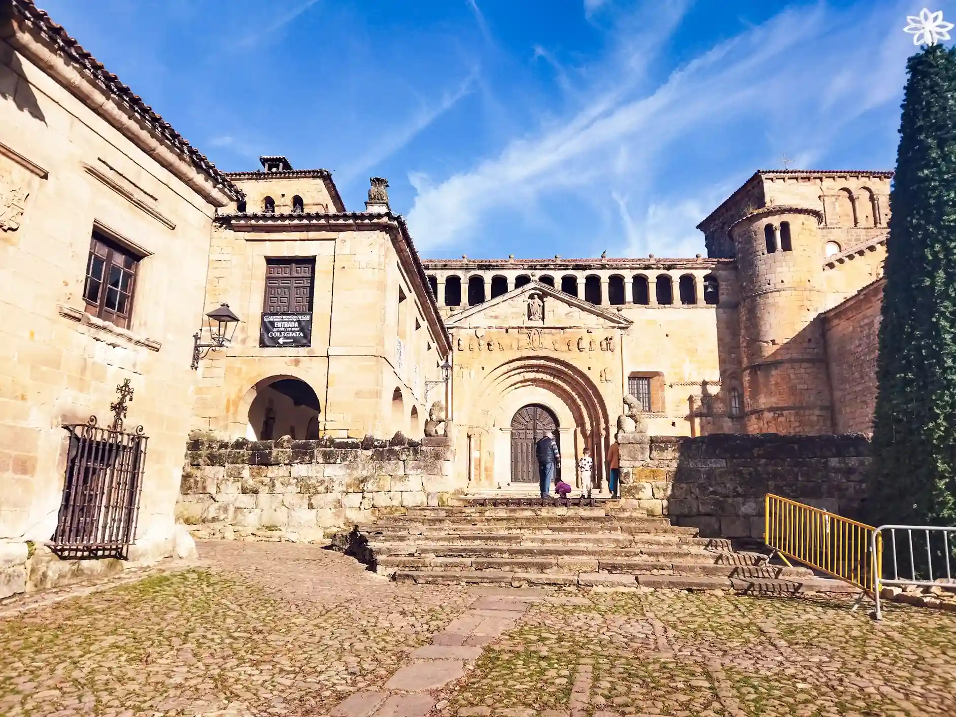 Edificio de piedra con el suelo empedrado en la entrada. Colegiata de Santillana del Mar.