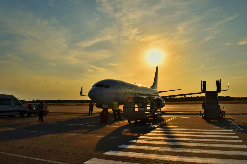 White airplane parked at an airport in daylight